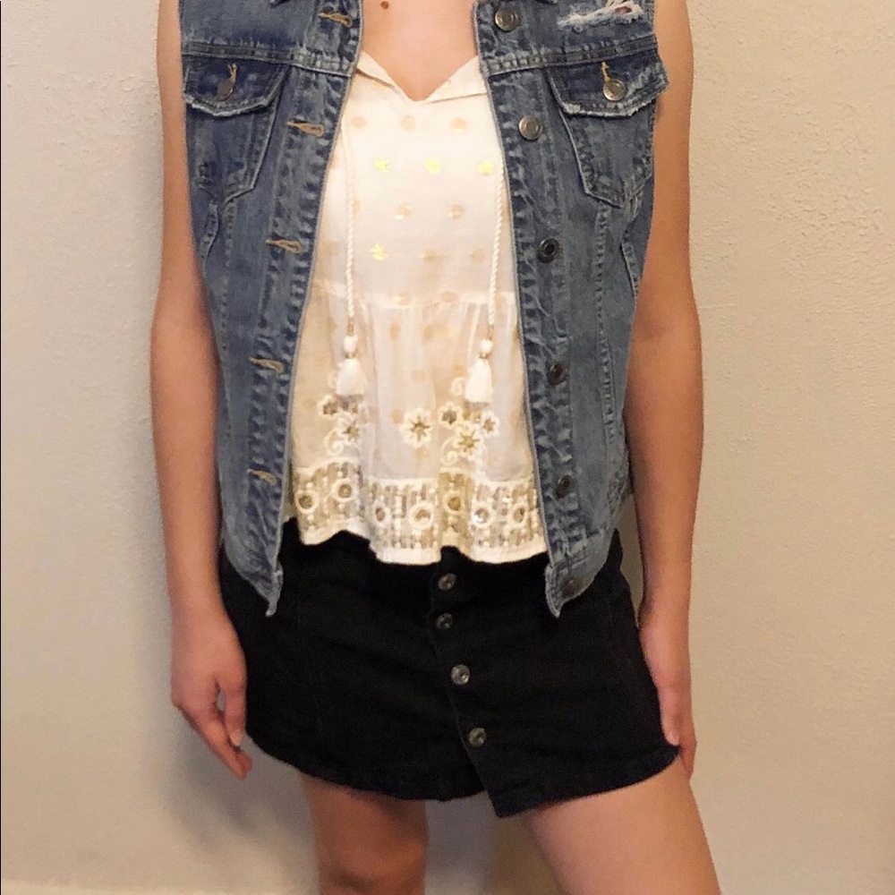 Distressed denim vest.